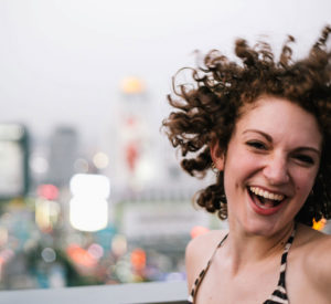 smiling woman caught in a candid shot with hair flipping